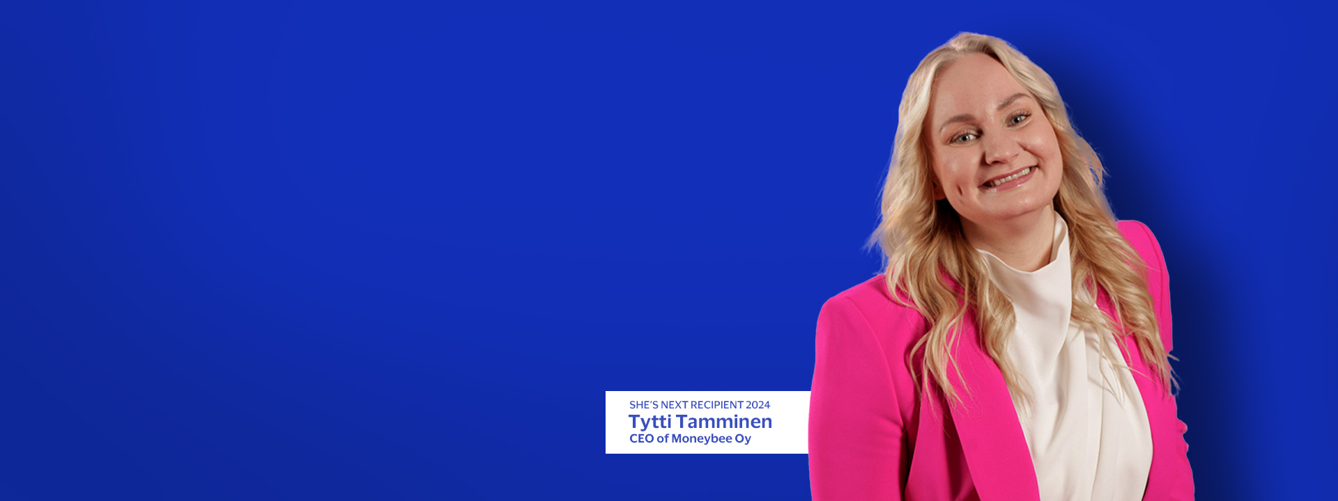 Tytti Tamminen smiling with blue background