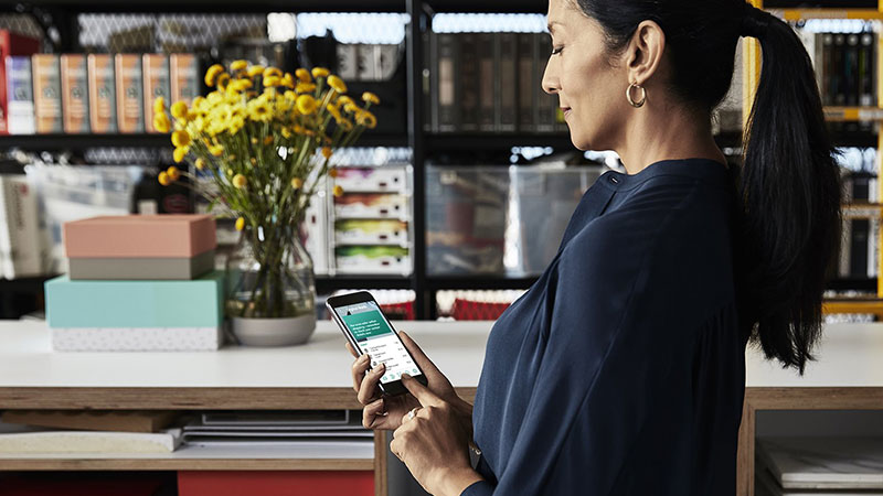 woman using her phone in shop