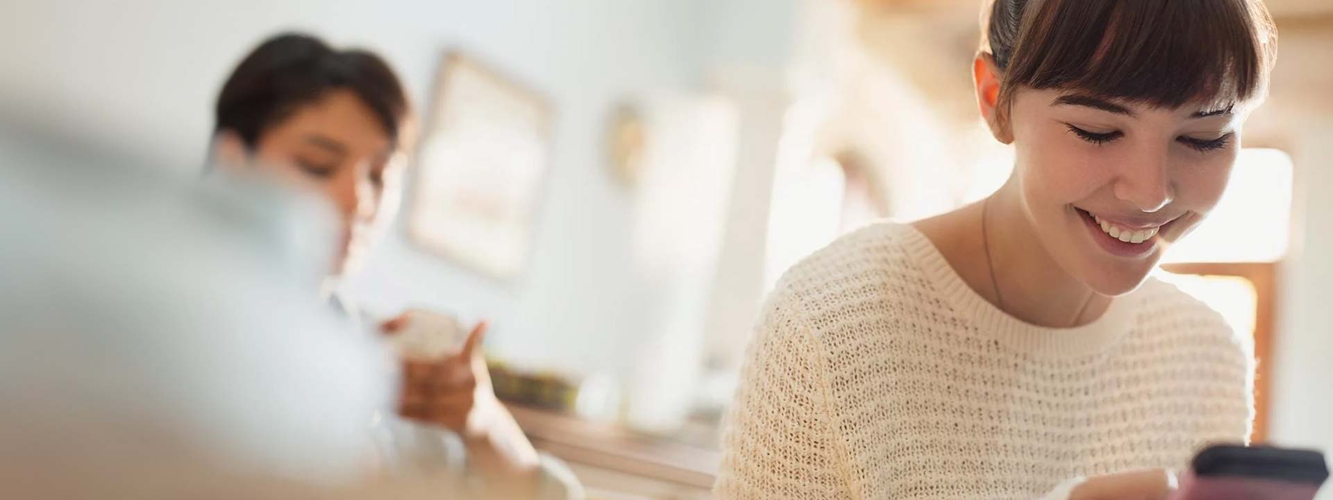 woman smiling at phone