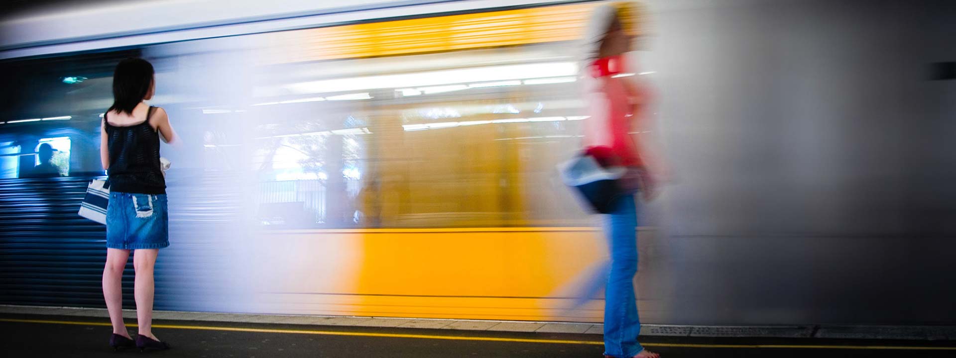 woman walking past moving train