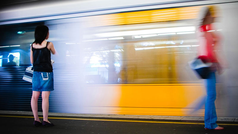 woman walking past moving train